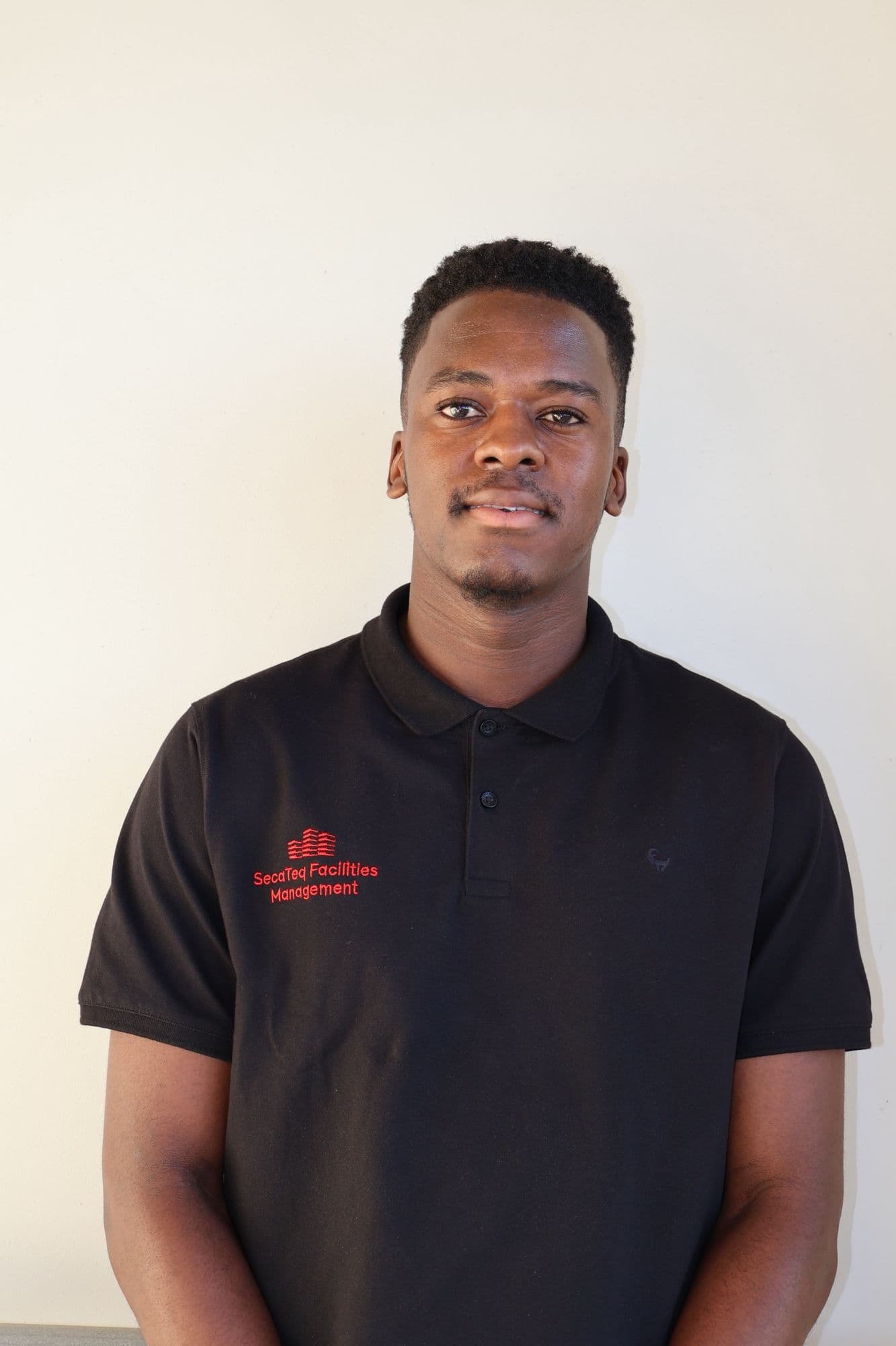 A SecaTeq FM technician in a SecaTeq Facilities Management shirt