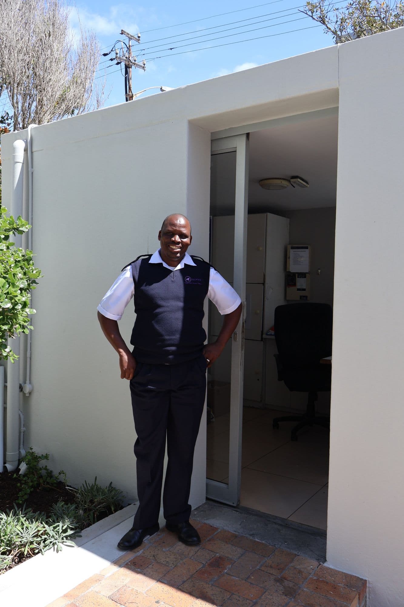 A SecaTeq officer at the entrance of a residential building