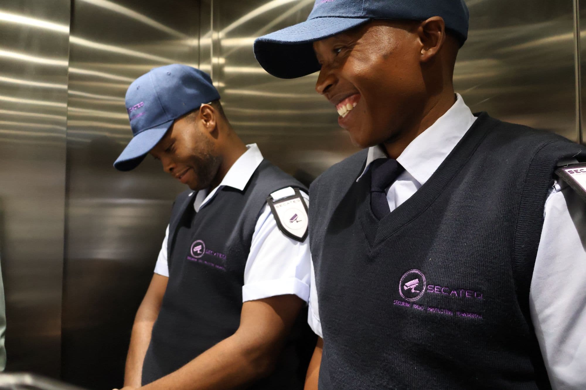 Two SecaTeq officers in a building lift