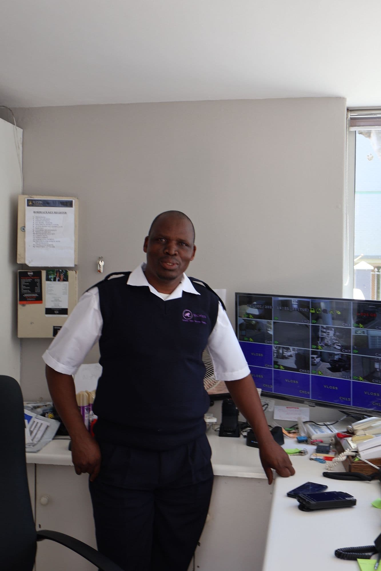 A SecaTeq officer at a desk with the site's camera screens