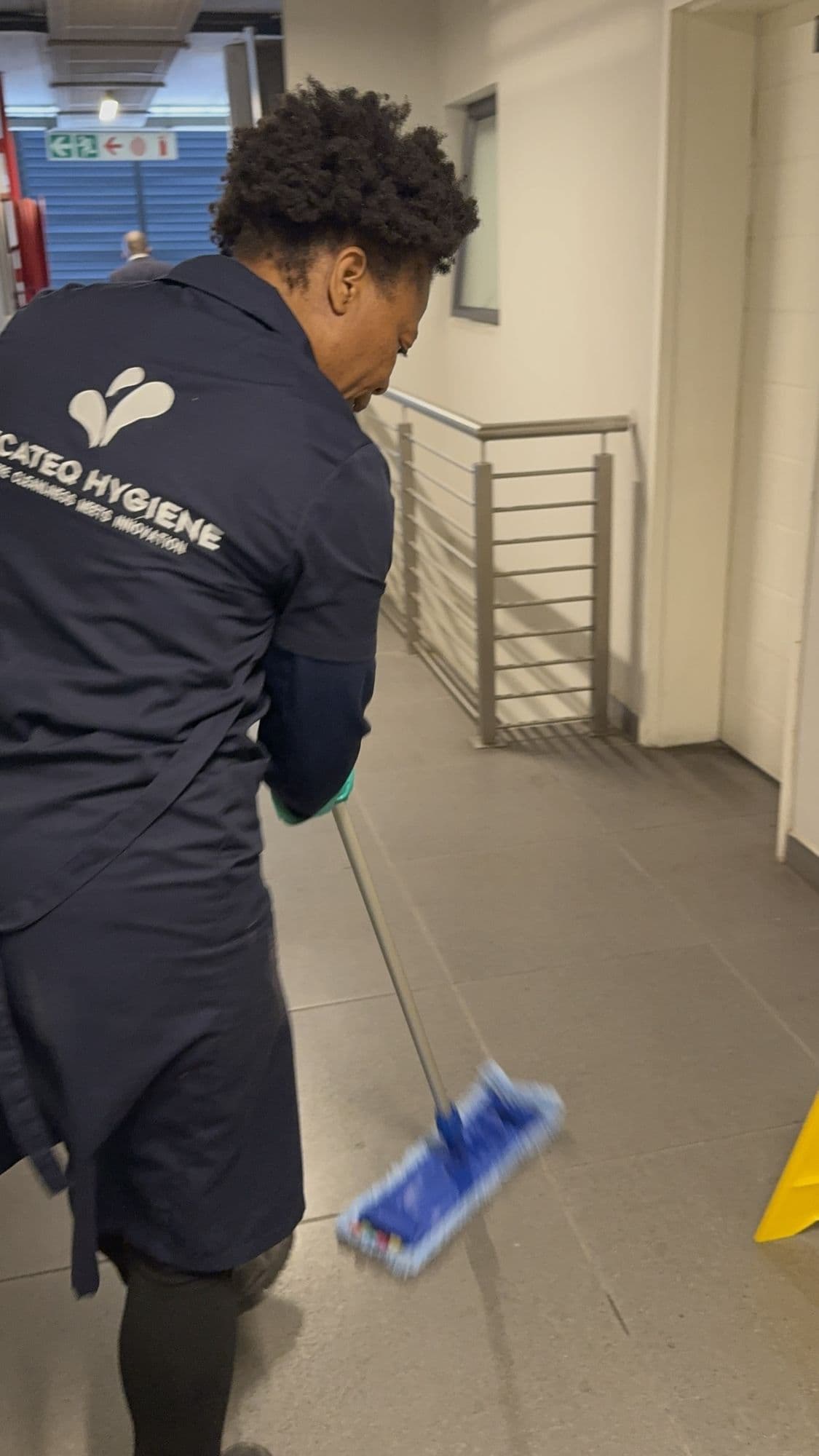 A SecaTeq Hygiene team member mopping a corridor floor